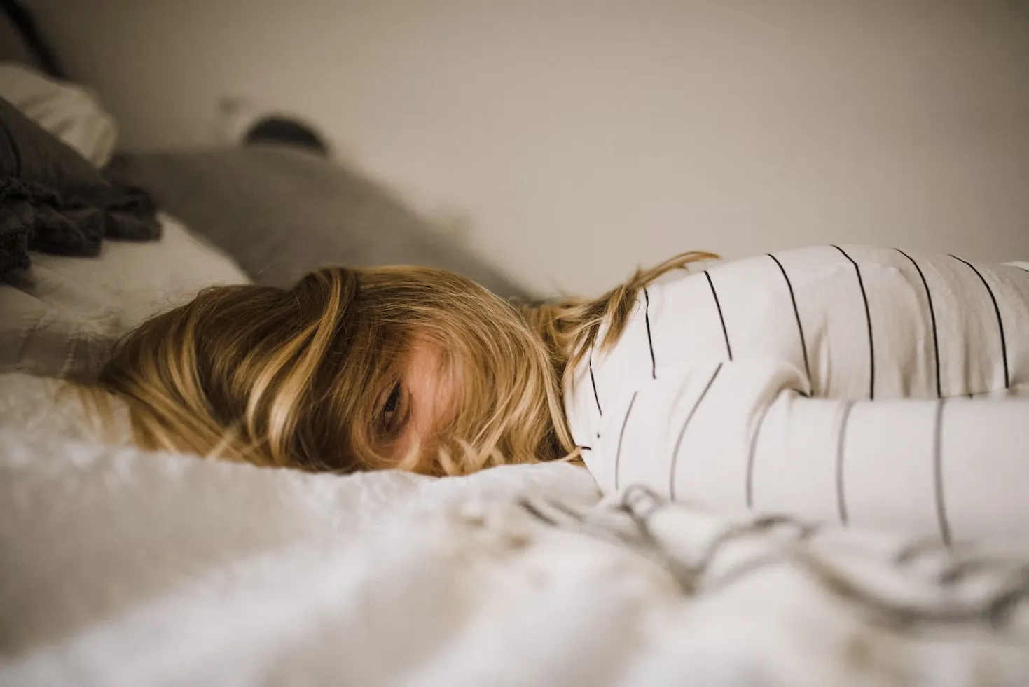 

A person sleeping peacefully in a comfortable bed, surrounded by a calming atmosphere.