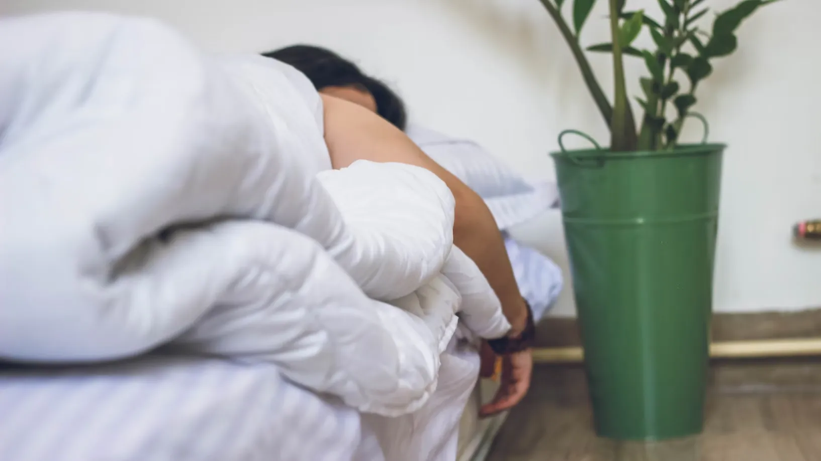 

A woman sleeping peacefully in bed, surrounded by calming blue and purple tones.